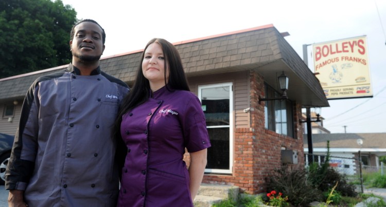 Bruce Hunter and Meagan McAvoy Hunter, stand outside Bolley’s Famous Franks and Gormet Burgers on College Avenue in Waterville on Friday. Bolley’s closed last month, and the two plan to open the new version in three weeks.