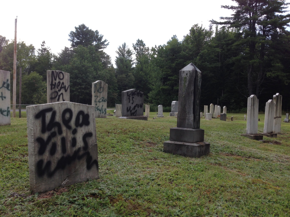 Grafitti defaces several gravestones Wednesday in Pleasant View Ridge Cemetery in China.