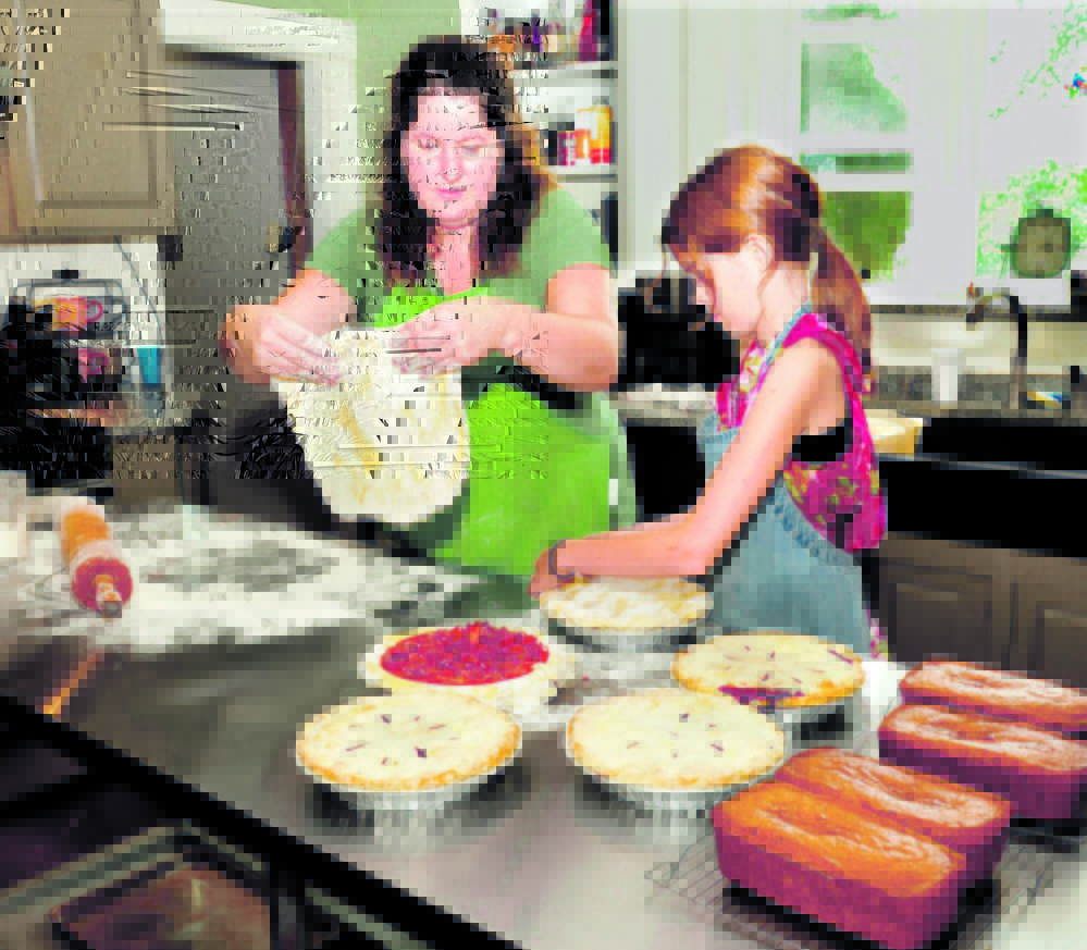 Jenny McLean and her daughter Hannah make pies in the kitchen of the McLean Family Farm and Bakery on South Reynolds Road in Winslow.