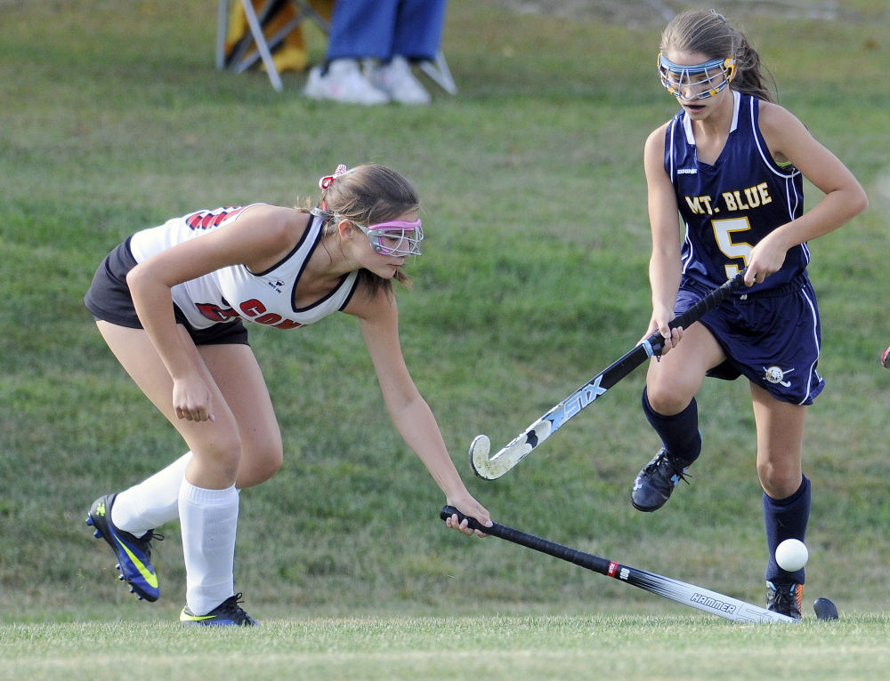 Staff photo by Andy Molloy 
 Cony High School's Julia Nicol, left, blocks the ball from Mt. Blue's Samantha Ellis during a Kennebec Valley Athletic Conference Class A game Tuesday in Augusta.