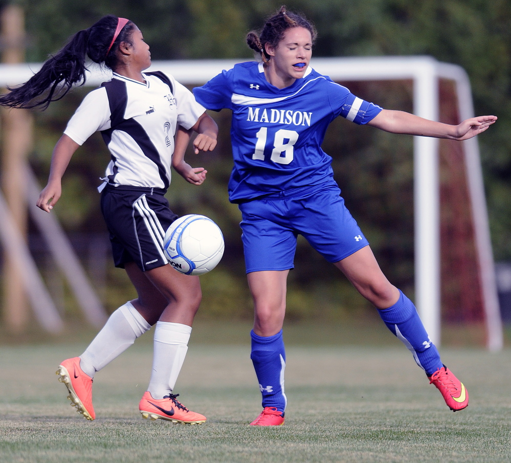 Staff photo by Andy Molloy 
 Hall-Dale High School's Lilly Ly, left, collides with Madison's Madison Curtis during a Mountain Valley Conference game Thursday in Farmingdale. Madison won 3-1.