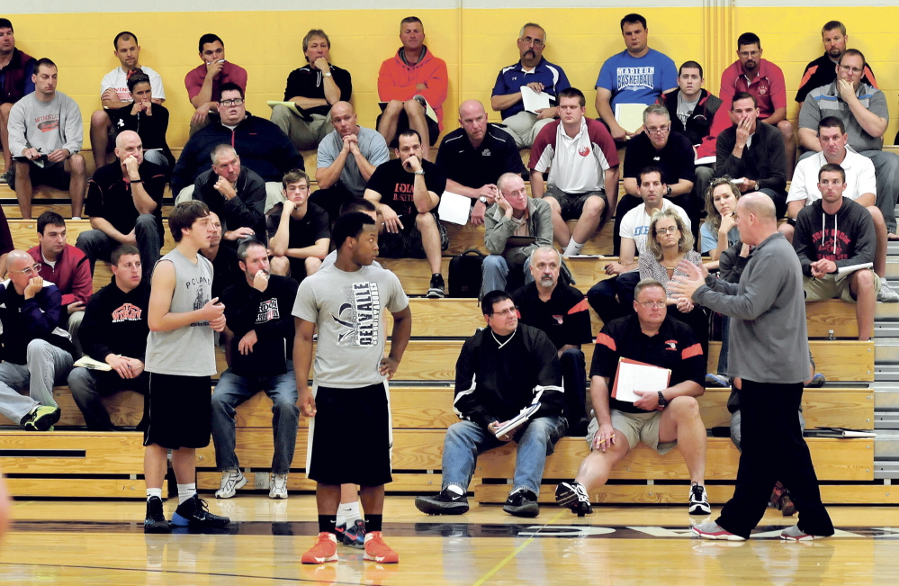 Basketball coaches listen as University of Maine at Farmington alum and current coach of the Charlotte Hornets Steve Clifford holds a clinic Sunday at Mt. Blue High School in Farmington.