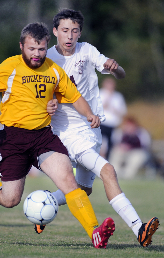 Richmond High School’s Cody Tribbett, right, attemptst to maneuver around Buckfield’s Jesse Warren during a Western D soccer game Tuesday in Richmond.