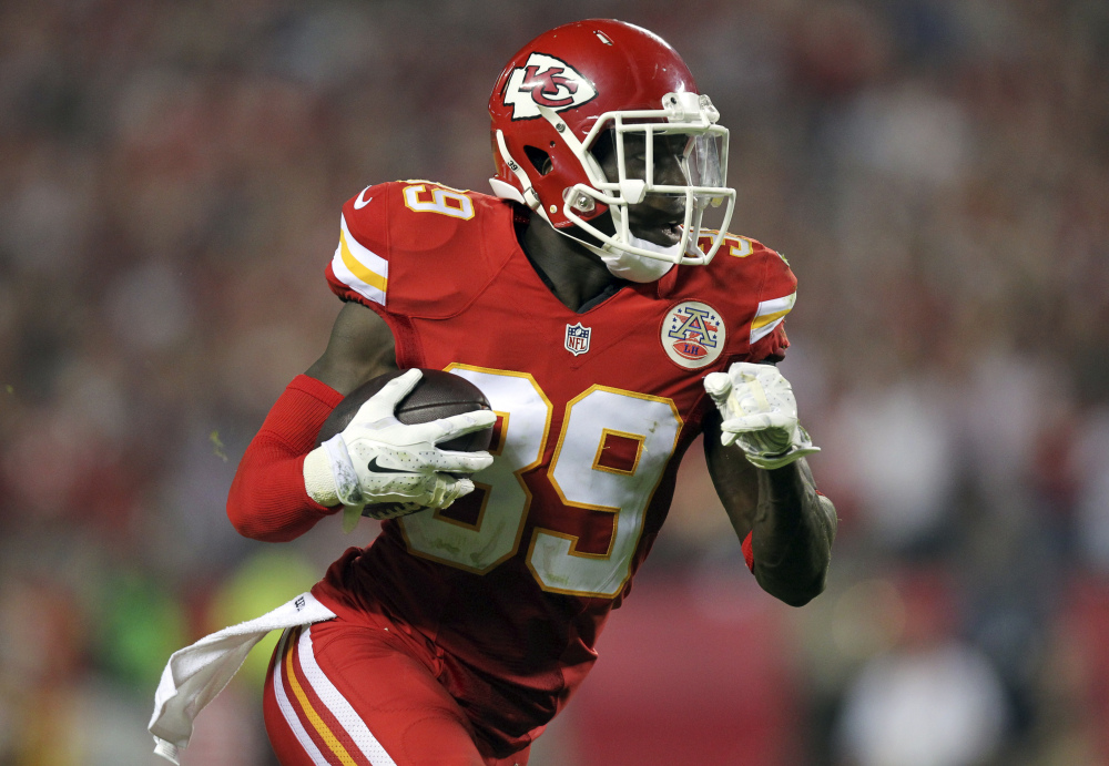 Kansas City Chiefs free safety Husain Abdullah carries the ball after intercepting a pass and running it back 39 yards for a touchdown during the fourth quarter of an NFL football game against the New England Patriots, Monday in Kansas City, Mo.