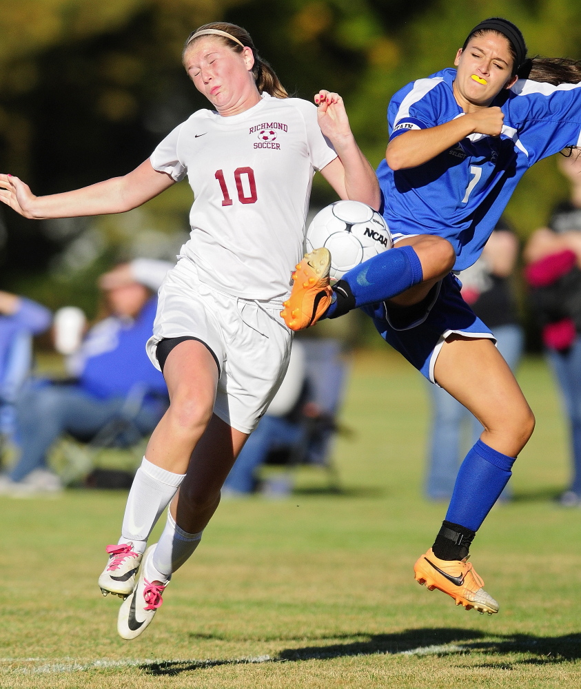 Richmond’s Kelsea Anair, left, collides with Sacopee defender Jade Jordan in front of the Sacopee goal during a game Thursday at Richmond High. Anair scored on a penalty kick to give the Bobcats a 1-0 victory.