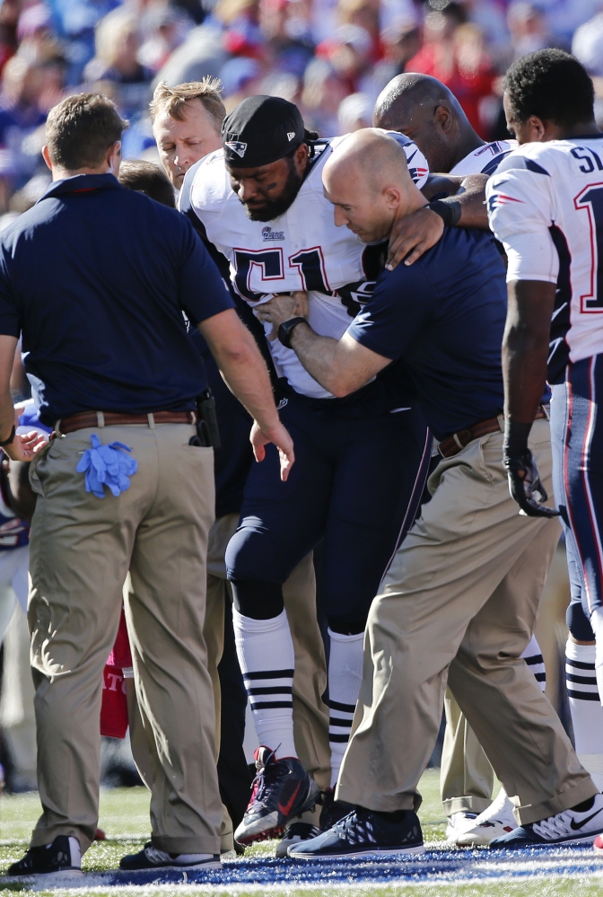 New England Patriots middle linebacker Jerod Mayo (51) is helped off the field during the first half Sunday against the Buffalo Bills in Orchard Park, N.Y. Mayo and running back Stevan Ridley will be out of Thursday’s game with the New York Jets.