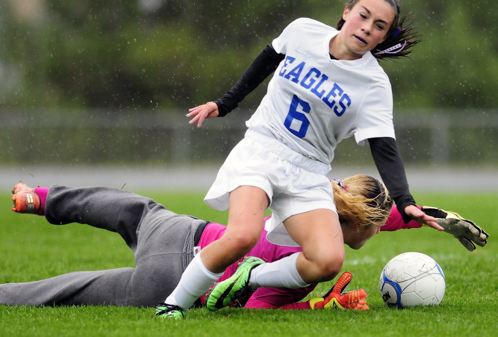 Lincoln keeper Miranda Achorn, left, makes a save as Erskine midfielder Lauren Wood collides with her during a game Tuesday in South China.