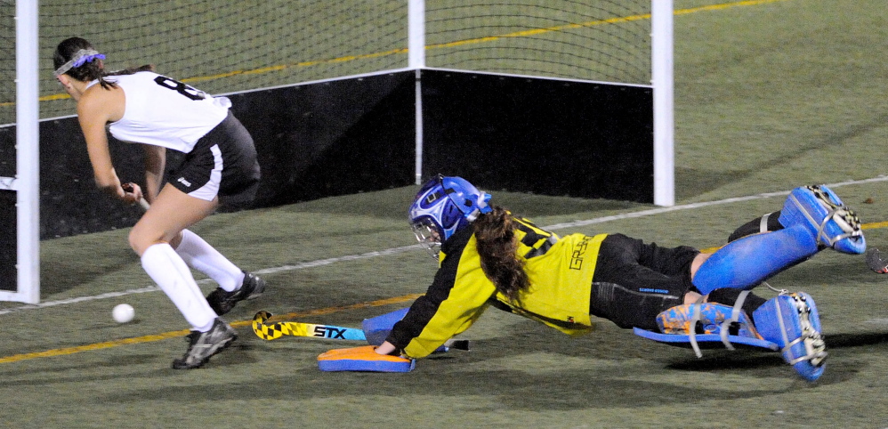 Skowhegan Area High School’s Brooke Michonski (8) scores a goal on Lawrence High School goalie Emily Tozier in the second half Thursday of the Eastern Class A title game at Hampden Academy. Skowhegan defeated Lawrence 2-0 for the Eastern Class A title.