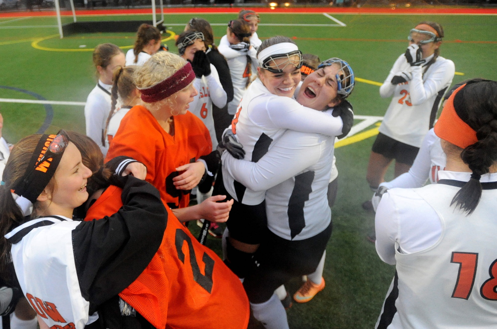 Members of the Winslow High School field hockey team celebrate their 3-1 win over Lisbon in the Class C state championship game Saturday at Thomas College in Waterville.