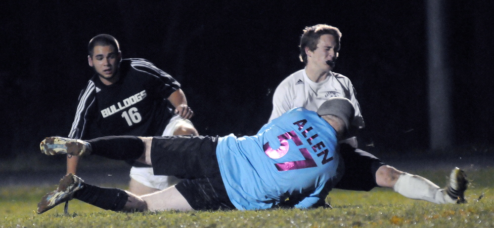 Maranacook Community High School’s Matty DuBois checks Hall-Dale High School’s Quinn Stebbins Wednesday during the Western C boys soccer championship game in Readfield.