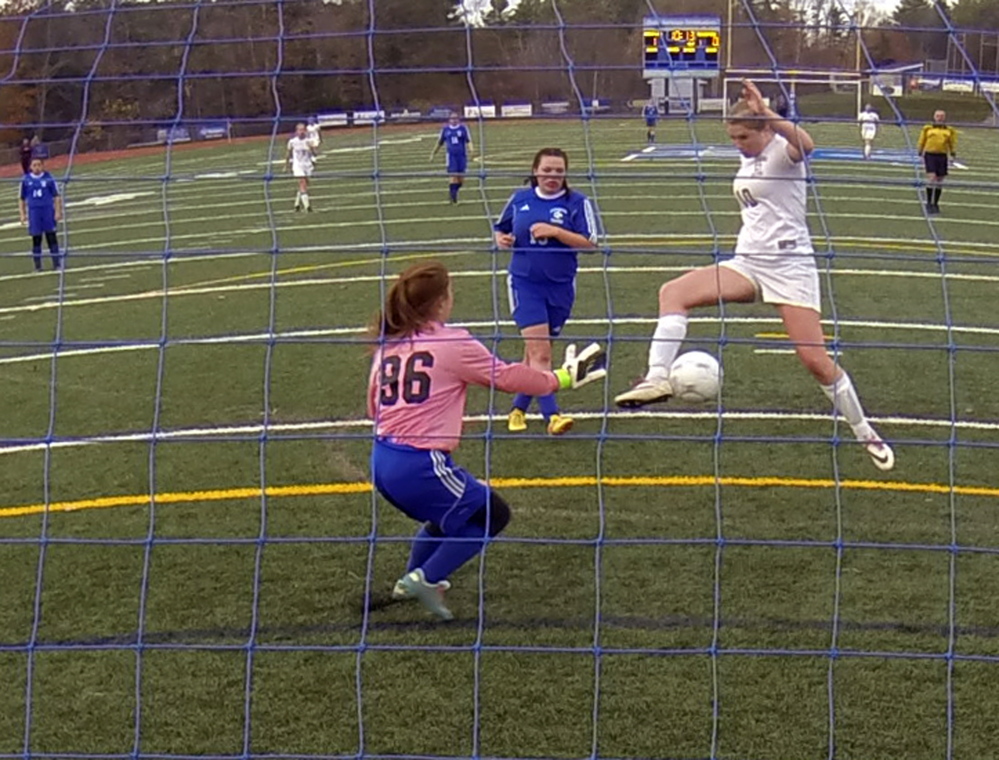 BATH, ME - NOV. 5: Richmond Bobcat Kelsie Anair lines the ball to kick in what will be her team's second goal against Searsport Vikings keeper Brooklynn Alberts during the Western Maine Class D girls soccer final on Wednesday November 5, 2014 at McMann Field in Bath. (Photo by Joe Phelan/Staff Photographer)