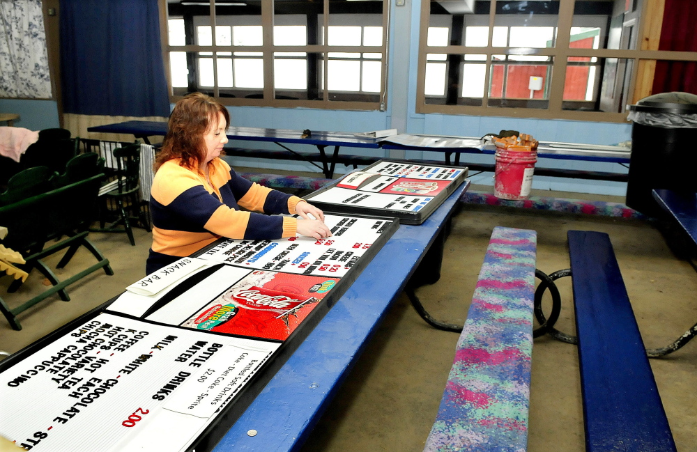 Eaton Mountain Ski Area manager Julie Keaten works on a menu board in the lodge that is undergoing renovation at the Skowhegan resort on Sunday.