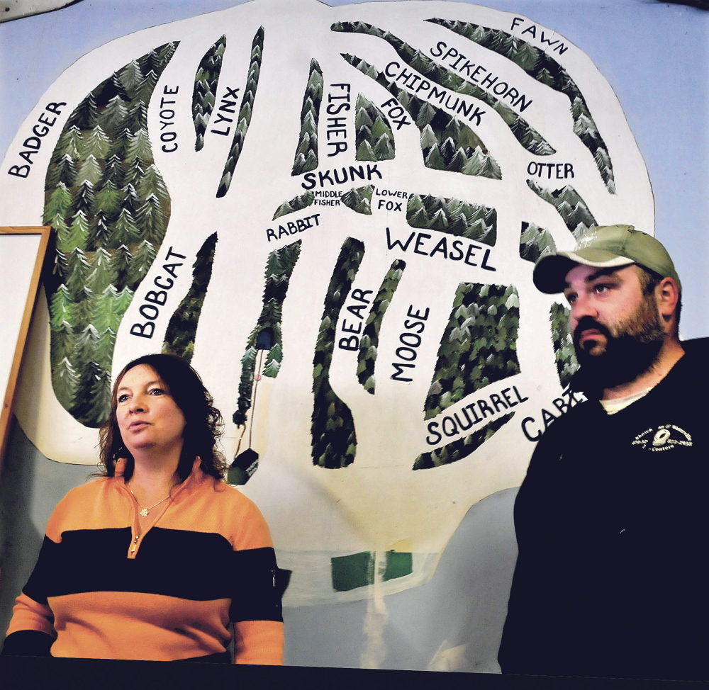 Julie Keaten, manager at Eaton Mountain Ski Area, and employee Jason Dumais were readying the resort on Sunday so that downhill skiing will be available this season on some of the trails designated in the map behind them for the first time since owner Dave Beers bought the business in 2008.