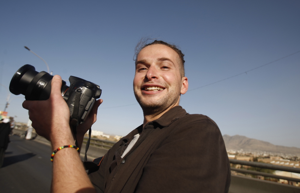 FILE - In this Monday, Feb. 11, 2013 file photo, Luke Somers, 33, an American photojournalist who was kidnapped over a year ago by al-Qaida, poses for a picture during a parade marking the second anniversary of the revolution in Sanaa, Yemen. Somers has been killed in a failed rescue attempt, his sister said Saturday, Dec. 6, 2014. Lucy Somers told The Associated Press that she and her father learned of her 33-year-old brother Luke Somers' death from FBI agents at 0500 GMT (12 a.m. EST) Saturday. (AP Photo/Hani Mohammed, File)