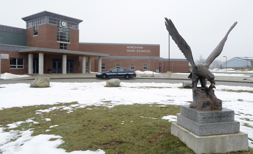 A Windham police cruiser is parked outside the Windham High School as a Windham school official, parents and students react to closure of schools due to a threat. The cruiser belongs to the school resource officer. John Patriquin/Staff Photographer