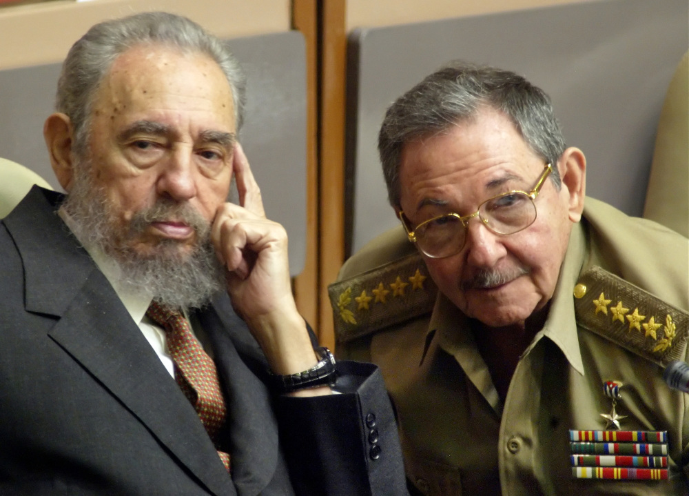 FILE - In this July 31, 2004 file photo, Cuba's President Fidel Castro, left, and his brother, Minister of Defense Raul Castro, attend a Parliament session in Havana, Cuba. The 1991 collapse of the Soviet Union devastated the Cuban economy, but the country limped along, first under Fidel and then, after he fell ill in 2006, under his brother Raul, head of the Cuban military. On Wednesday, Dec. 17, 2014, the U.S. and Cuba agreed to re-establish diplomatic relations and open economic and travel ties, marking a historic shift in U.S. policy toward the communist island after a half-century of enmity dating back to the Cold War. (AP Photo/Cristobal Herrera, File)