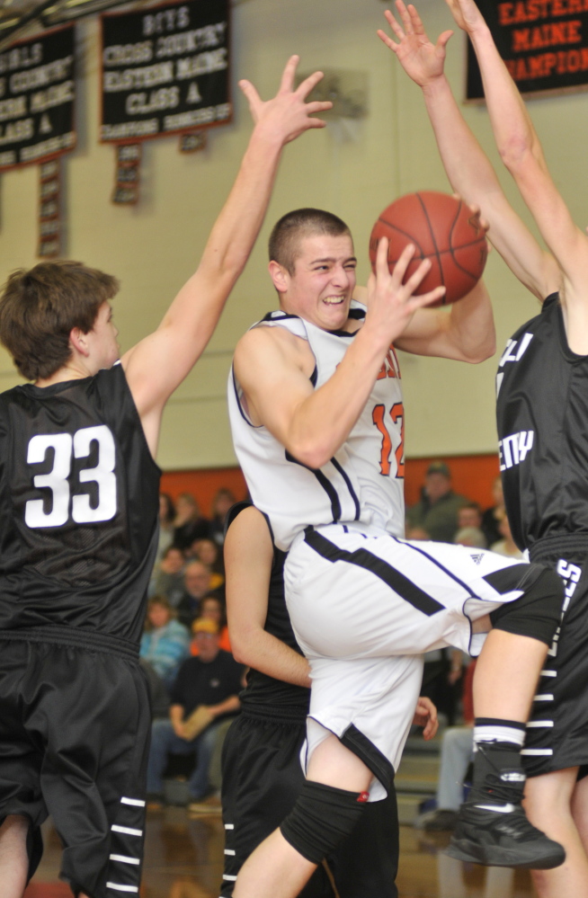 Gardiner’s Seth McFarland, middle, tries to get a shop up past Lincoln Academy’s Cocy Tozier during a game Friday in the James A. Bragoli Memorial Gym at Gardiner Area High School.