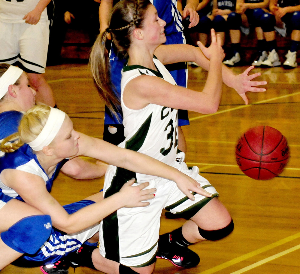 Jerzee Rugh, right, goes after a loose ball as Madison’s Madeline Wood tries to stop her during Monday’s game in North Anson.