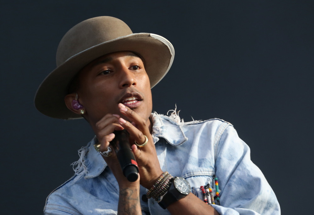 In this Friday, July 4, 2014, file photo, Pharrell Williams performs on the main stage at Wireless festival in Finsbury Park, in London. Pharrell and Sam Smith will perform at the Grammys next month.