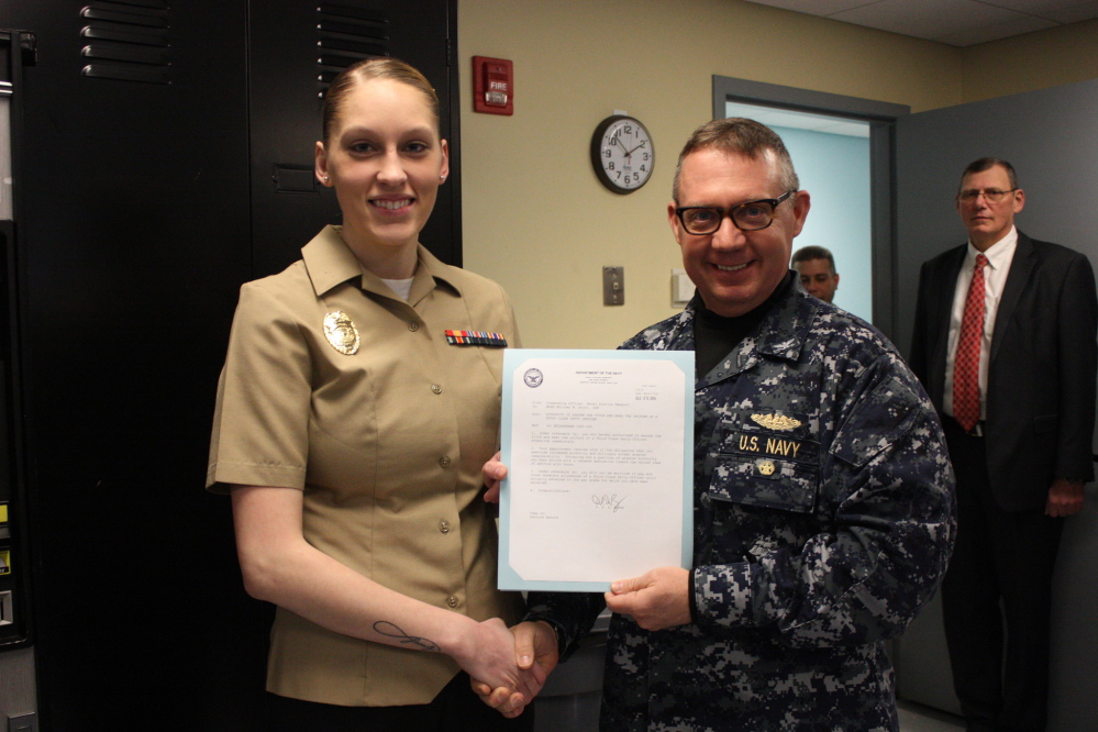 MA Seaman Whitney Scott, left, with  Commanding Officer of Naval Station Newsport, Captain Dennis Boyer.