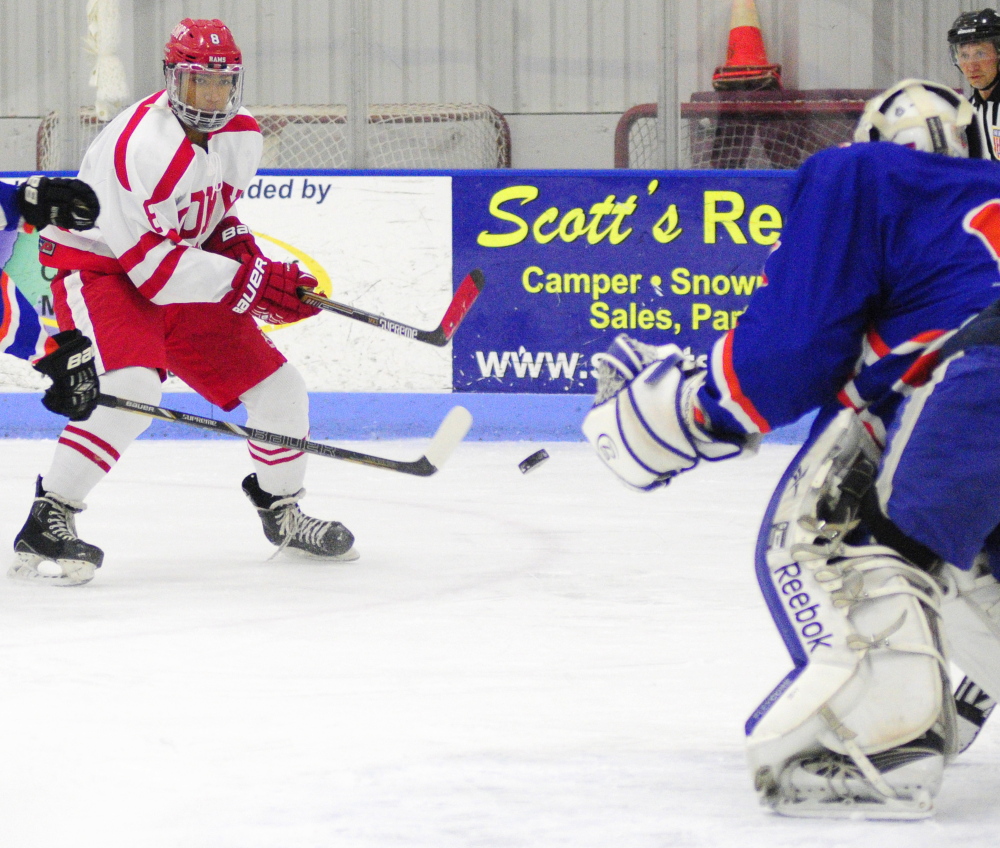 Cony’s Cameron Wilson takes a shot on Lawrence/Skowhegan goalie Curtis Martin during an Eastern A game Thursday at the Bank of Maine Ice Vault in Hallowell.