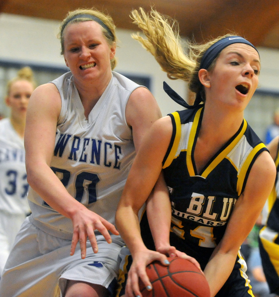 Lawrence High School’s Jordyn Towers, left, battles for the rebound with Mt. Blue High School’s Caitlin Kane in the first half at Lawrence High School in Fairfield on Saturday.