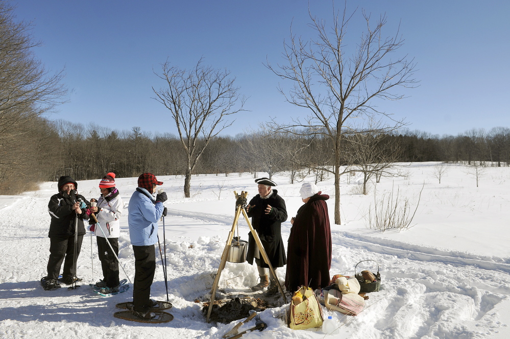 Snowshoers stop for soup Sunday at Old Fort Western’s table during the Table Tour at Viles Arboretum in Augusta.