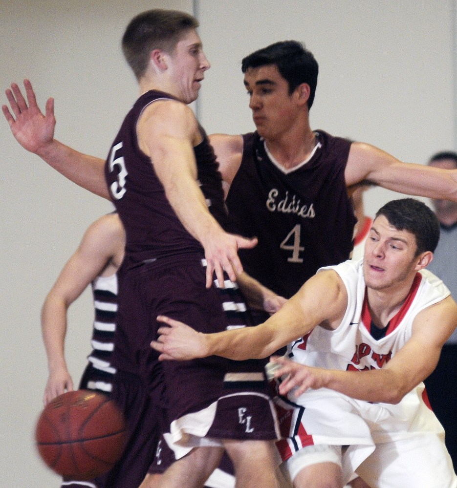 Staff photo by Andy Molloy 
 Cony High School's T.J. Cusick gets off a pass as he's swarmed by Edward Little defenders during a Kennebec Valley Athletic Conference Class A game Tuesday night in Augusta.