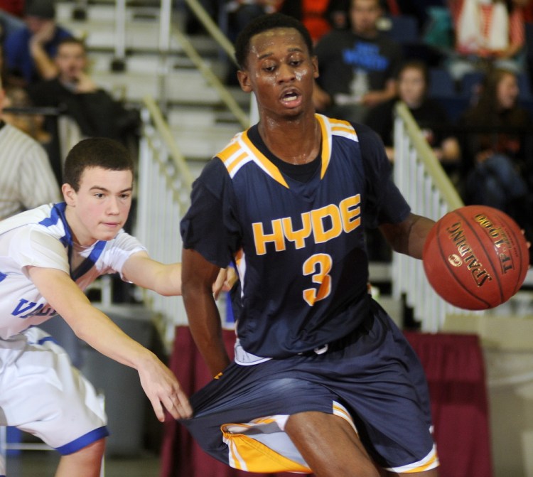 Valley High School’s Nathan Ames draws a foul on Hyde School’s Antoine Montgomery during the final minutes of a Western Class D semifinal game in Augusta Wednesday.