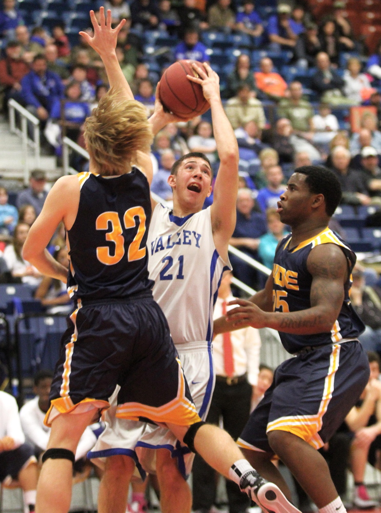 Valley High School’s Collin Miller attempts to put up a shot between Hyde School’s Frederik Lasson (32) and Shemar Jack (25) during the first half the Cavaliers’ 61-47 loss in a Western Class D semifinal game at the Augusta Civic Center on Wednesday.