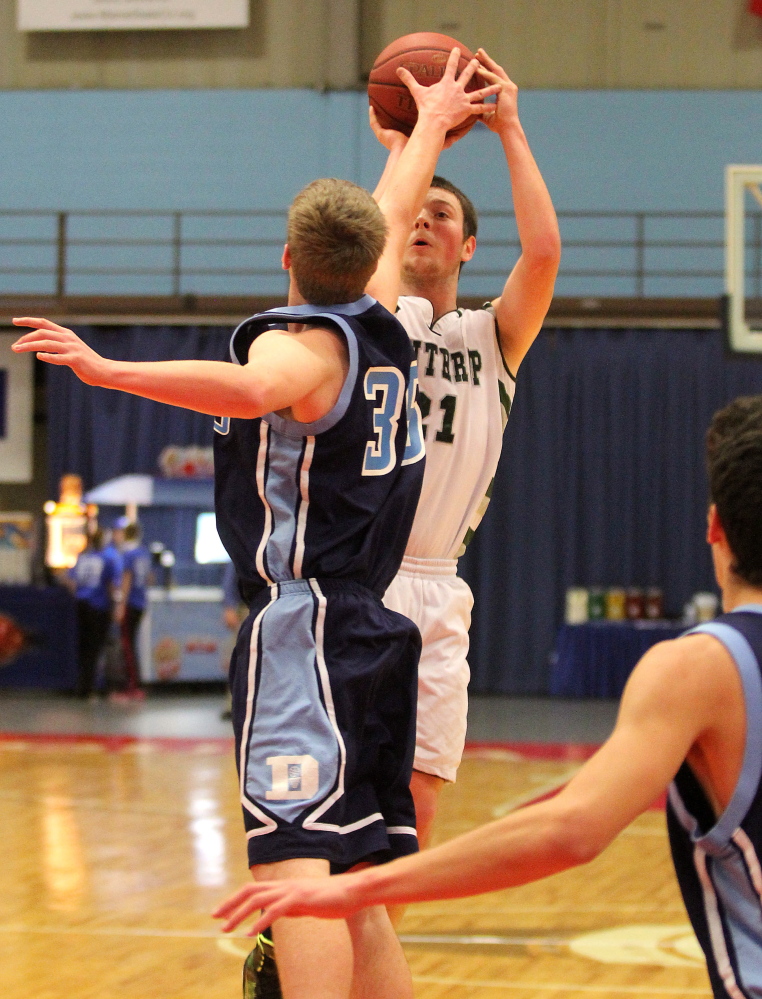 Winthrop High School’s Matt Sekerak keeps his eyes on the basket while shooting over Dirigo’s Clay Swett in the first half of a Capital City Hoop Classic game at the Augusta Civic Center.