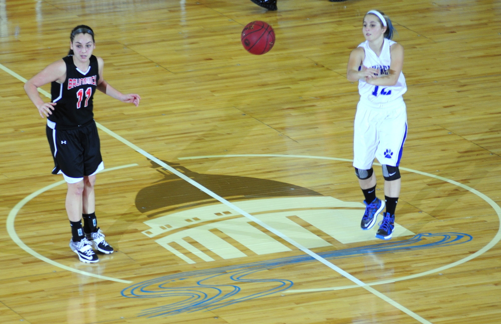 Brunswick’s Julia Champagane, left, watches as Lawrence’s Dominique Lewis passes at midcourt during an Eastern A semifinal Wednesday at the Augusta Civic Center.