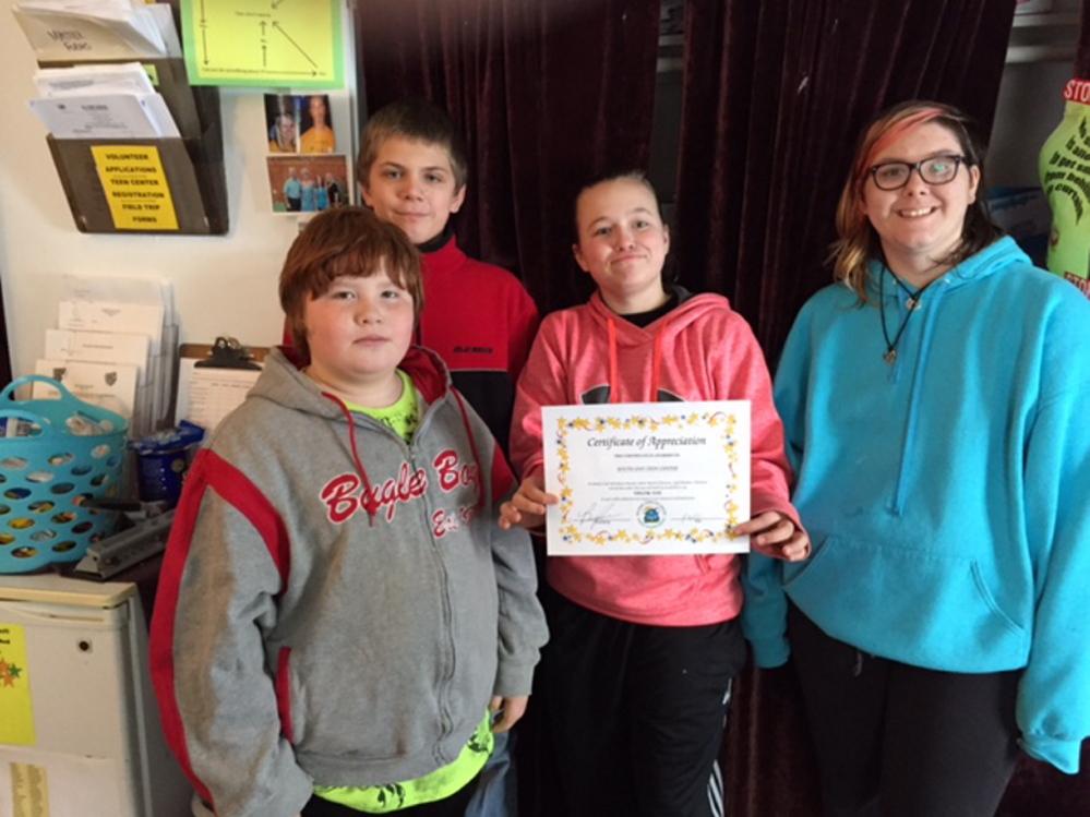 CAP.cutline_standalone:Waterville’s South End Teen Center members, from left, Jacob Eads, Kaleb Moulten, Lauren Demo and Charlie Williams display a certificate from the Mid-Maine Homeless Shelter in recognition for being a community helper. The teens sold crafts during the holiday season and then donated to help the shelter.