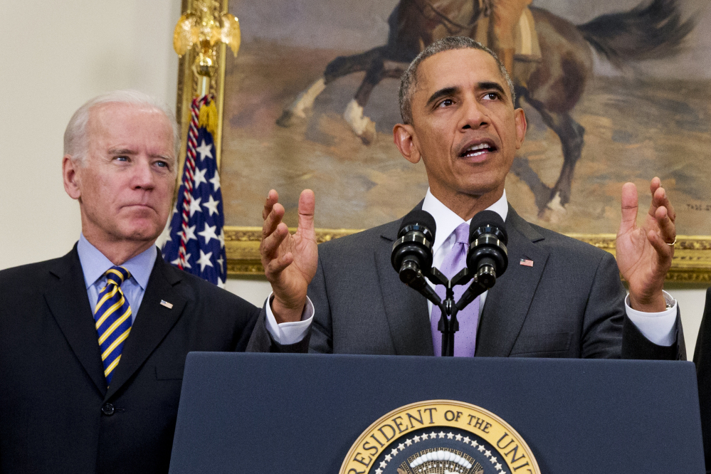 In this Feb. 11, file photo, Vice President Joe Biden listens as President Barack Obama speaks about the Islamic State group, Wednesday, in the Roosevelt Room of the White House in Washington.