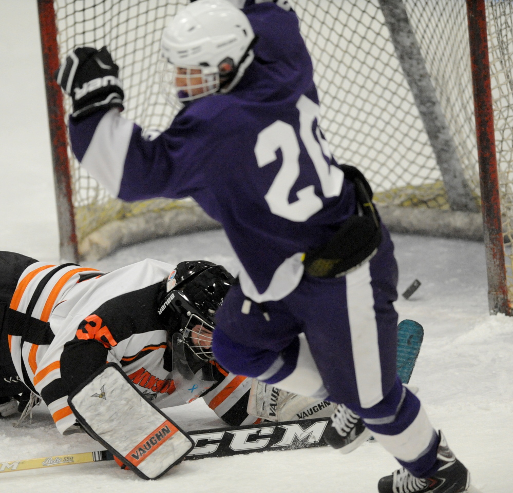 Hampden’s Marcus Dunn right, celebrates after a goal in the first period of an Eastern B quarterfinal Tuesdya night.