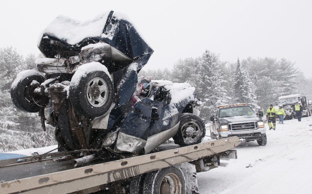 Carmel, Maine-02-25-2015-- What is left of a pick up truck is hauled away from a mutiple car pileup on intersate 95 in Carmel. 
 Kevin Bennett Photo