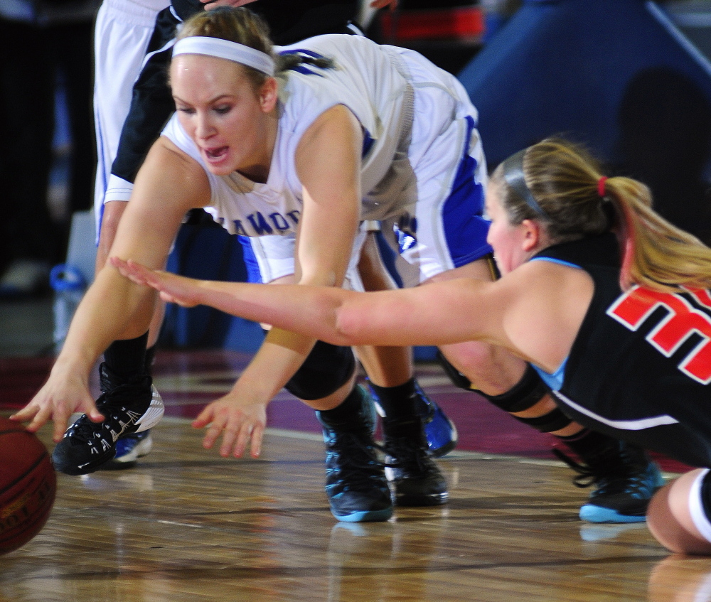 Lawrence’s Nia Irving dives after a loose ball contested by Brunswick’s Kolby Levesque during an Eastern A semifinal game at the Augusta Civic Center last week.