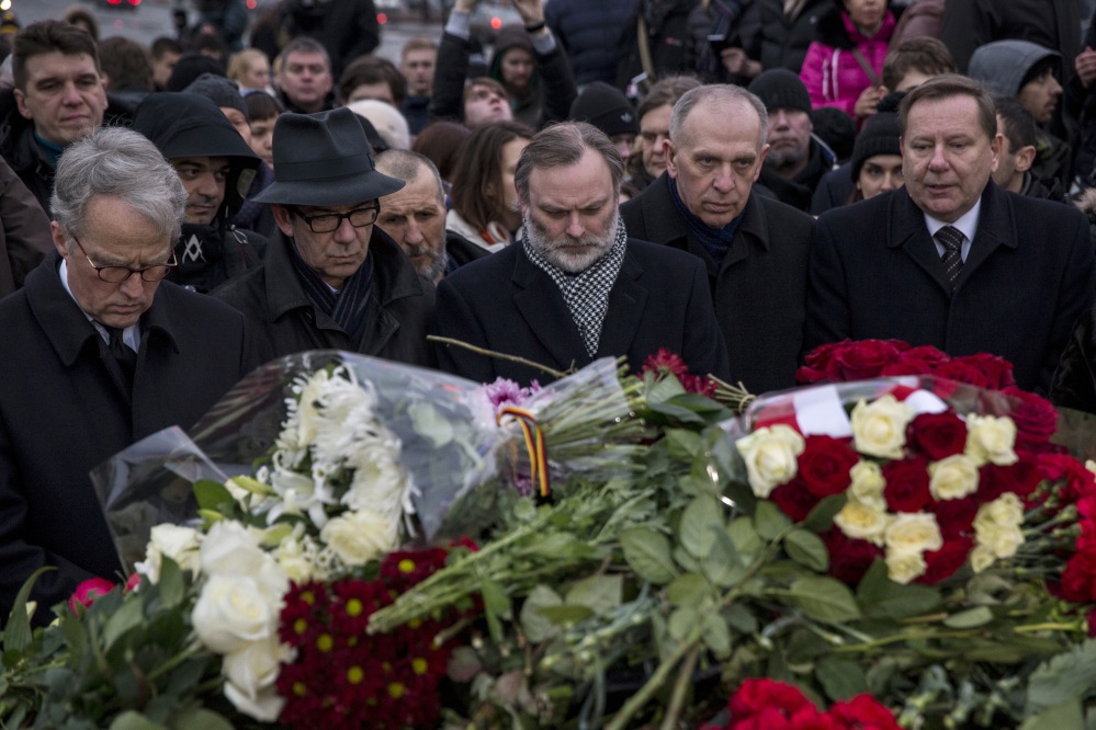 A group of EU ambassadors to Russia lay flowers at the place where Boris Nemtsov, a charismatic Russian opposition leader and sharp critic of President Vladimir Putin, was gunned down, at Red Square, with St. Basil Cathedral in the back and the Kremlin at left, in Moscow, Russia, Saturday.