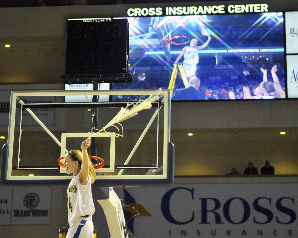 Washburn District High School’s Mackenzie Worcester, 14, celebrates with the net after defeating Rangeley Lakes High School 60-54 in the Maine Principal’s Association Class D championship basketball game at the Cross Insurance Center in Bangor on Saturday.