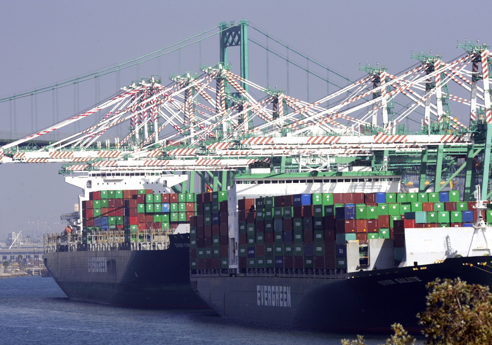 Freighters and cargo containers sit idle at the Port of Los Angeles as a backlog of over 30 container ships sit anchored outside the port on Wednesday. U.S. Labor Secretary Tom Perez planned to hold a second round of talks with shipping company executives and union leaders for 20,000 dock workers on Wednesday, seeking to broker a deal to end months of labor turmoil clogging cargo traffic at 29 West Coast ports.