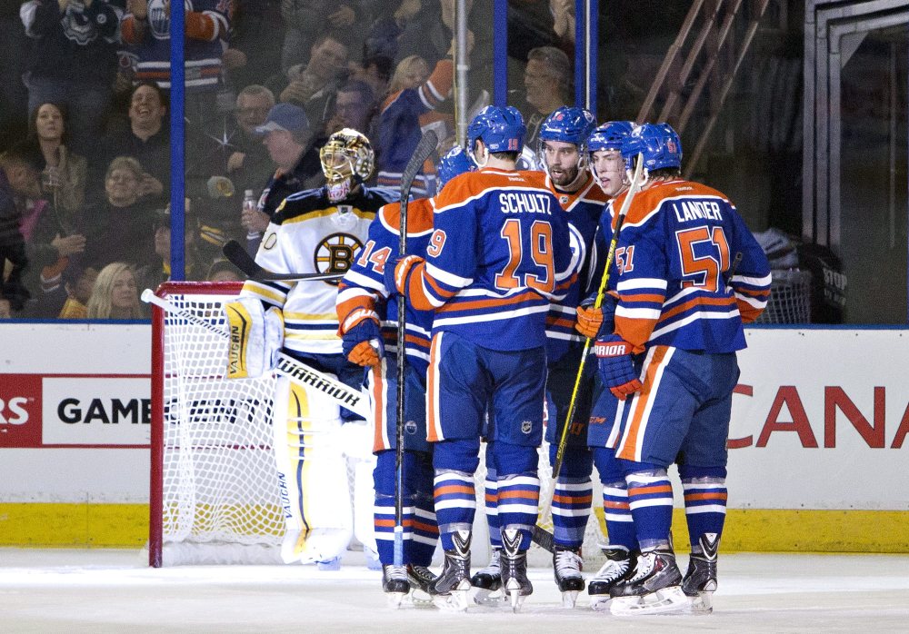 Boston Bruins goalie Tuukka Rask looks on as the Edmonton Oilers celebrate a goal during the first period of Wednesday night’s game in Edmonton, Alberta.