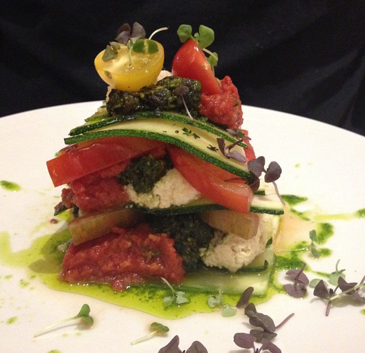 A raw vegan lasagna prepared by chef Matthew Kenney in Miami Beach. The lasagna is layered with zucchini, tomatoes, macadamia ricotta, spicy marinara, pistachio pesto and olive oil. 