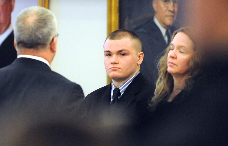 Kyle Dube, center, with his attorneys Stephen Smith, left, and Wendy Hatch is in court during the first day of Dube's trial at the Penobscot Judicial Center in Bangor on Monday. The Associated Press