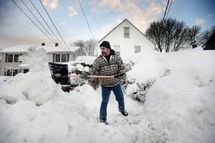 Sean Gallagher shovels a path in front of his High Street home in Saco on Thursday morning. Shawn Patrick Ouellette/Staff Photographer