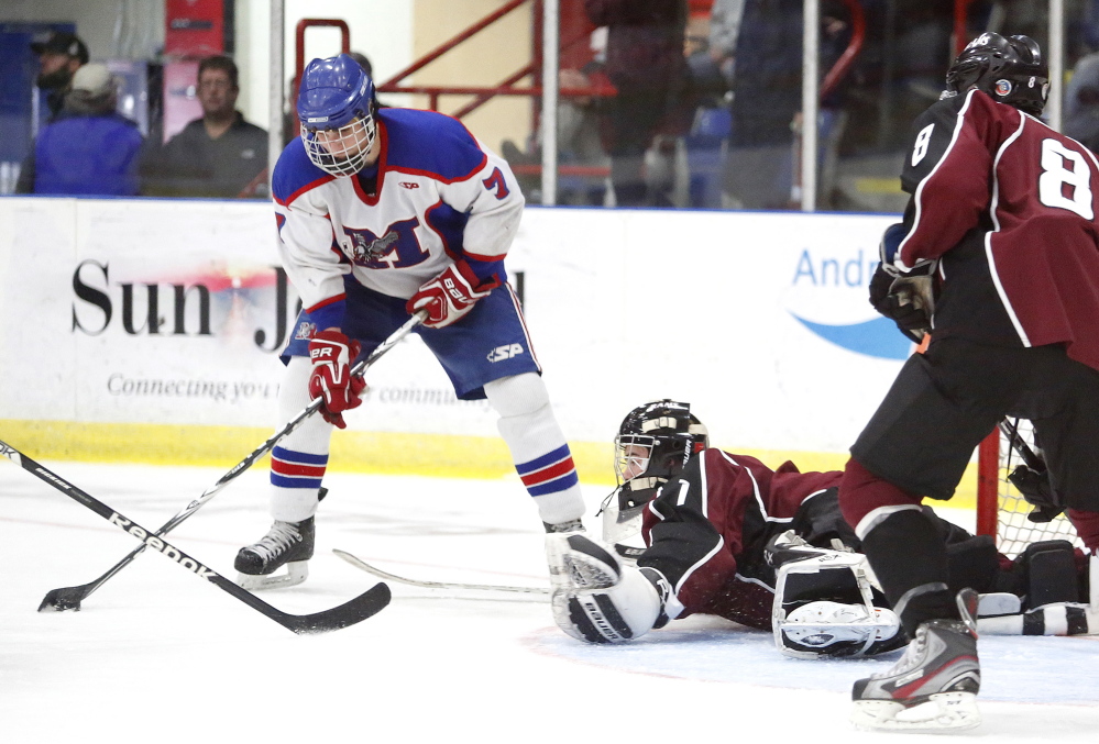 Justin Broy of Gorham hits the ice to block a shot attempt by Jake Dexter of Messalonskee last year in the Class B state championship game at the Colisee in Lewiston. The Eagles play Winslow on Tuesday night for the regional title and a shot to move on to the Class B title game in Lewiston. Messalonskee is on a 16-game win streak.