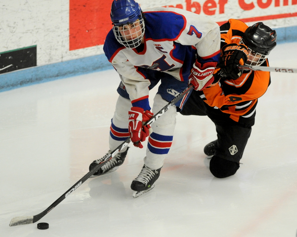 Messalonskee High School’s Jake Dexter (7) skates by Winslow High School’s Jacob Houghton (4) in the third period of the Eastern Class B East championship last week at Alfond Arena at the University of Maine.