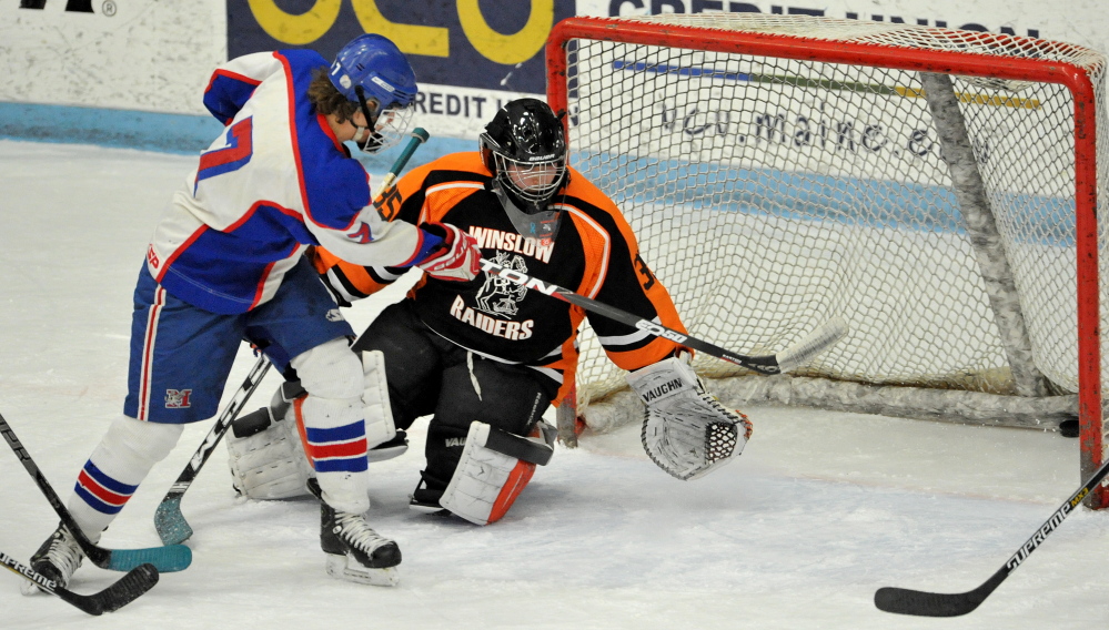 Messalonskee High School’s Jake Dexter (7) scores on Winslow goalie Andrew Beals (35) in the first period of the Eastern B title game Tuesday in Orono. Dexter and the Eagles will play for the Class B state title Saturday against Gorham.