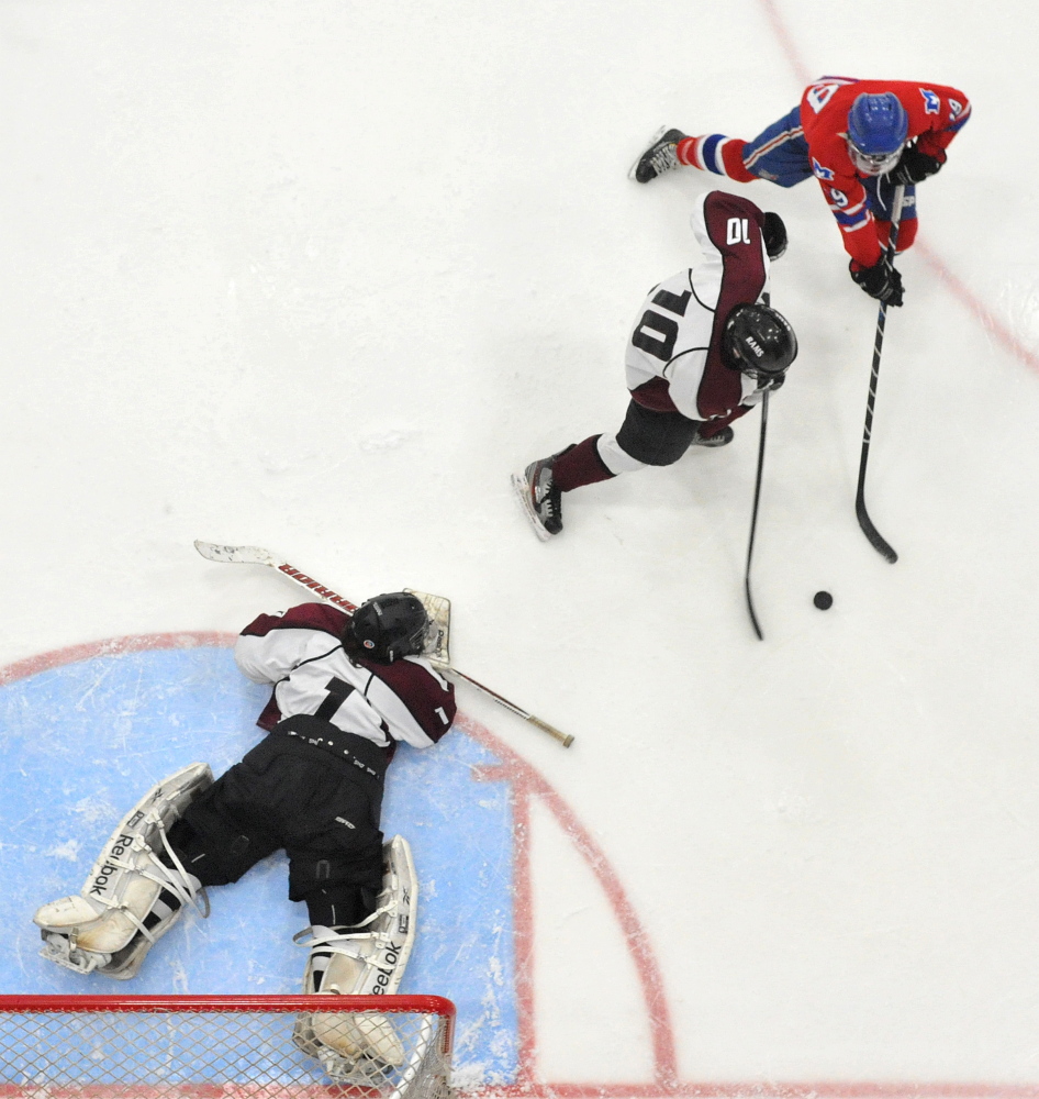 Messalonskeeforward Jared Cunningham, left, tries to score as Gorham’s Andrew Schmidt (10) defends in the second period Saturday.