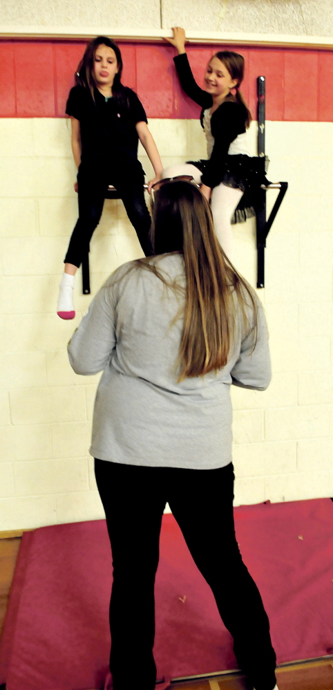 Christina Fisher, left, and Alanna Pelletier show their skills to Messalonskee High School student Annie Dobos during a Big Brothers Big Sisters gathering Wednesday at Williams Elementary School in Oakland.