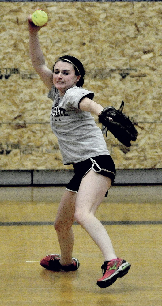 Messalonskee High School pitcher Kirsten Pelletier fires a pitch on the first day of practice for pitchers and catchers Monday in Oakland.